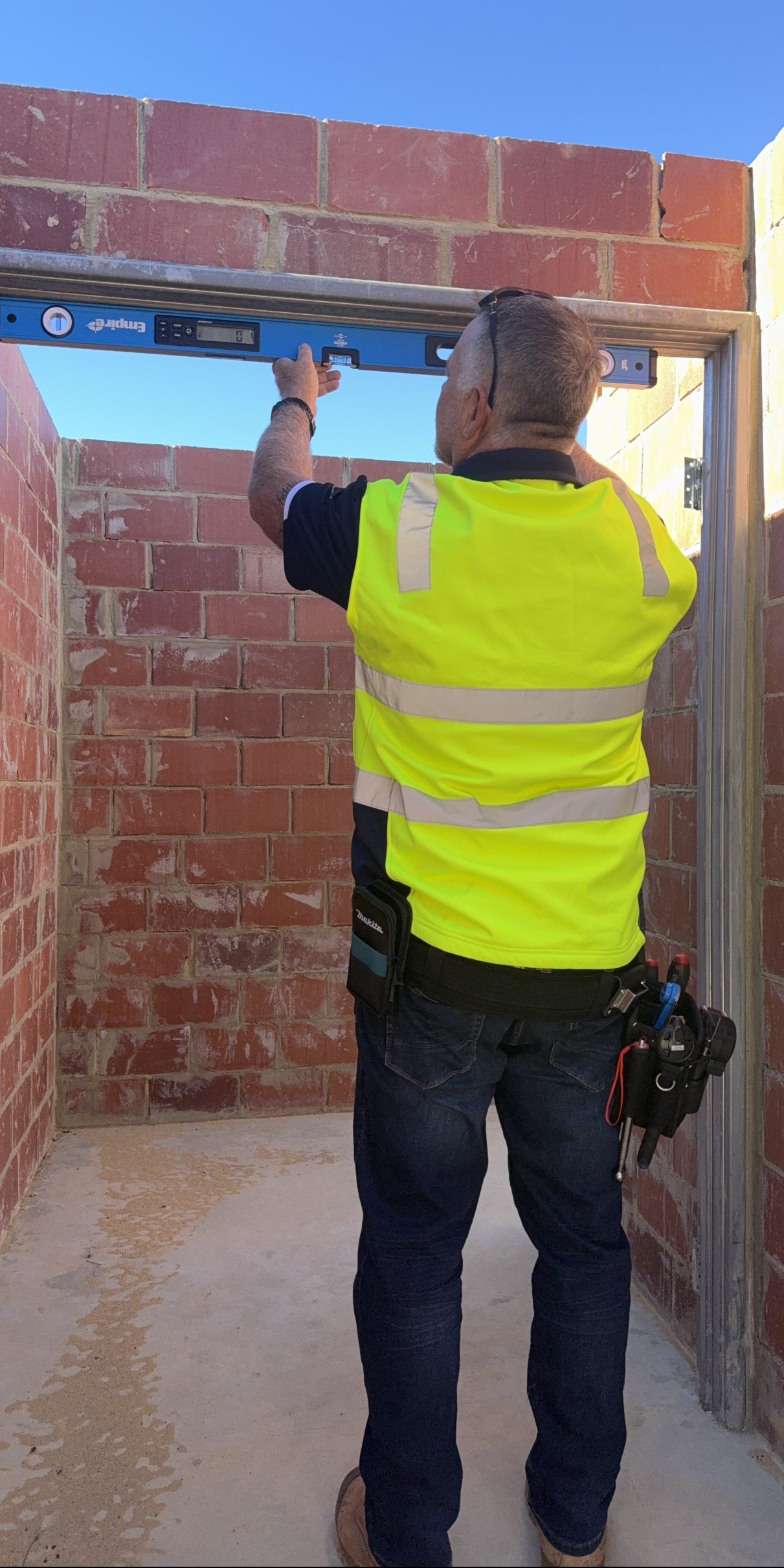 BuildNex WA inspecting workmanship with a digital level